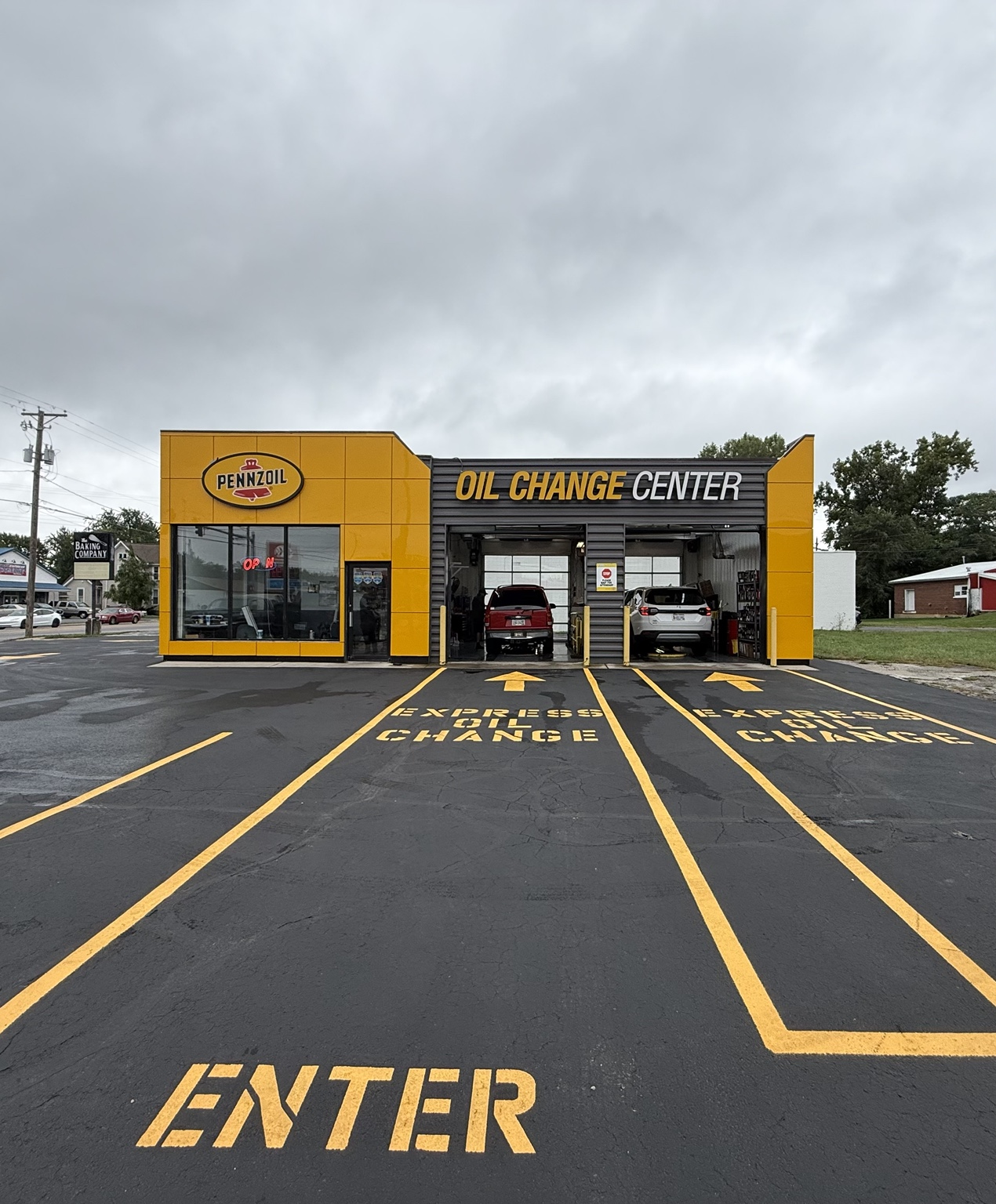 Front exterior view and entrance lanes at the Pennzoil Oil Change Center on East Sandusky Street